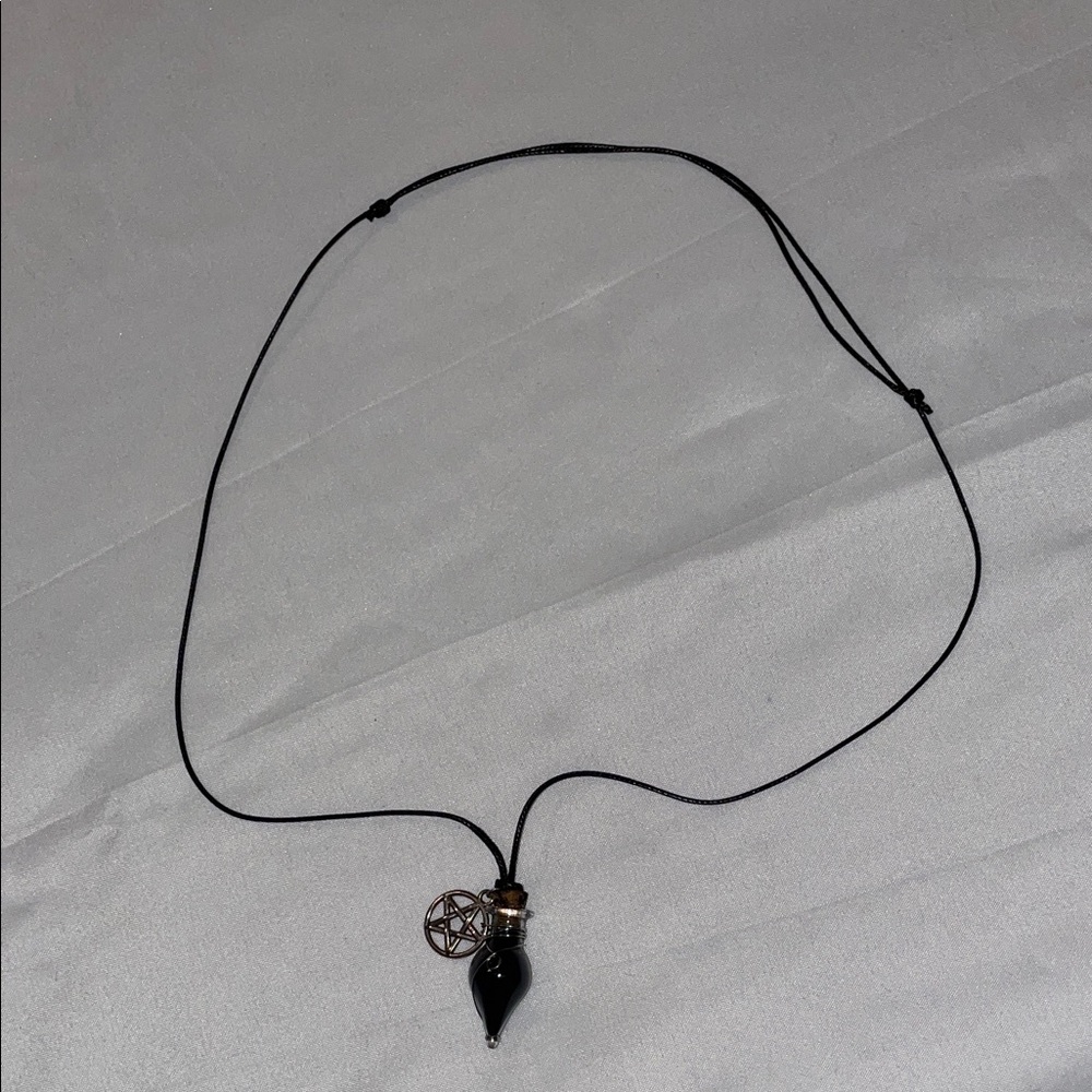 Black strap necklace with pentagram and potion charm